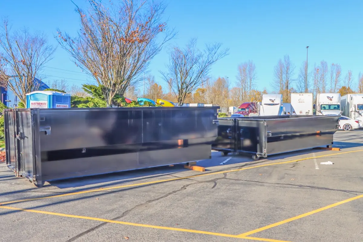 Professional dumpster rental service with roll-off container on residential driveway in Elmira